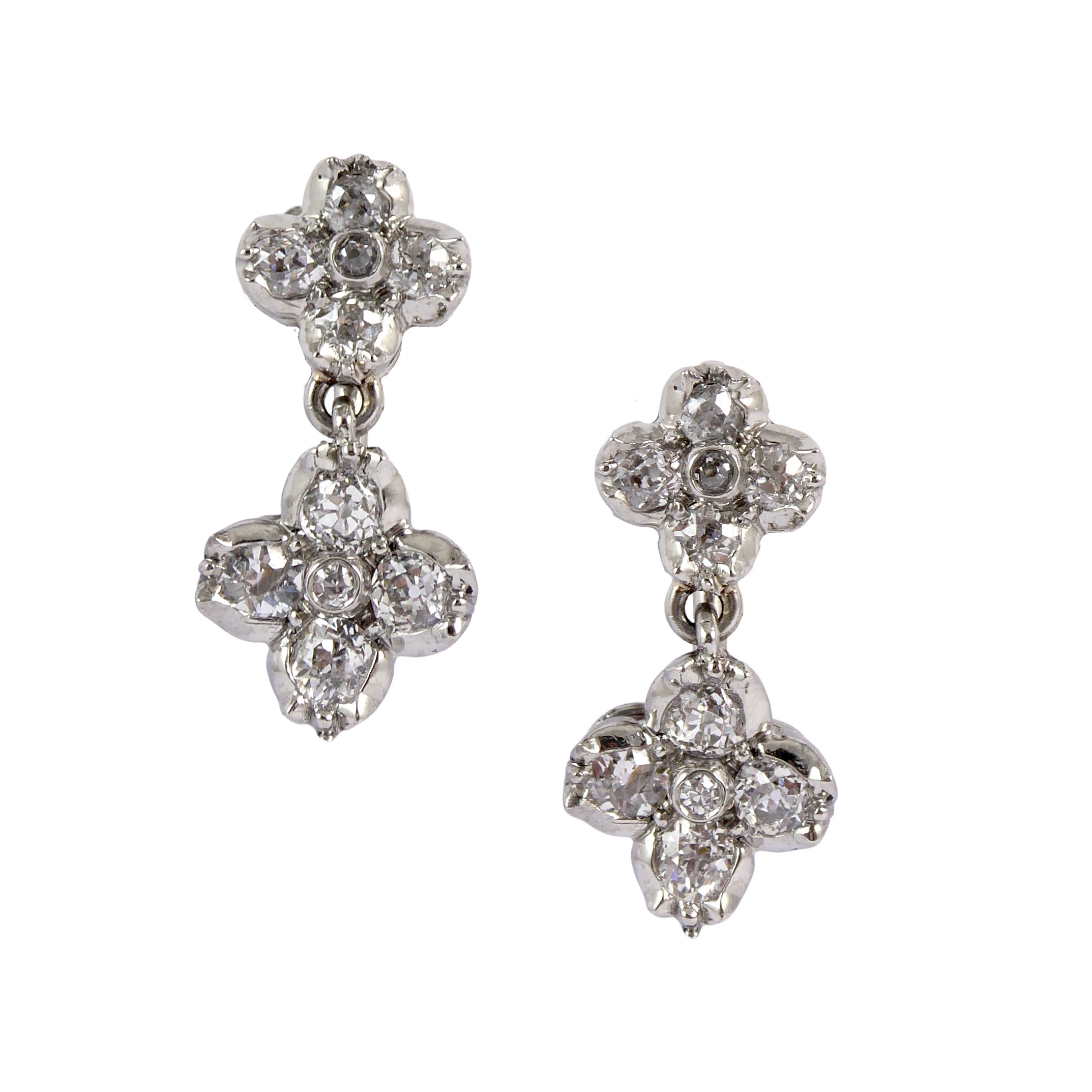 Pair of diamond quatrefoil cluster pendant earrings, early to mid-20th century, with two graduated flowerheads,
